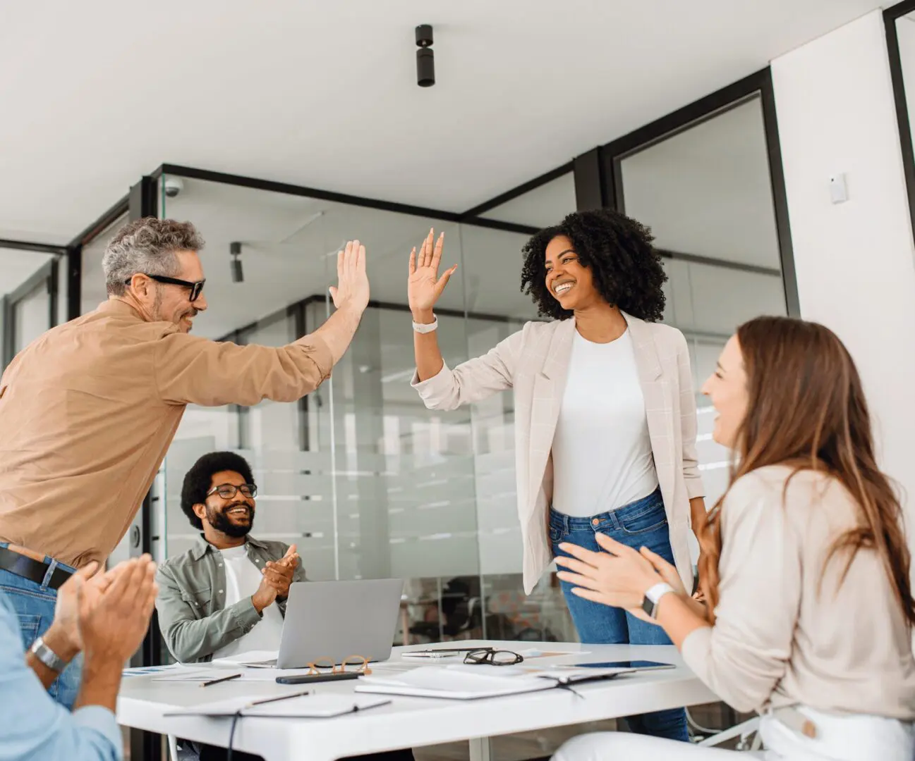 People celebrating success with high five.